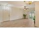Open-concept living area featuring stylish flooring, ceiling fan, and sliding glass doors to the outside at 3823 Parkridge Cir # 1-101, Sarasota, FL 34243