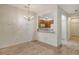 Open-concept living space with modern flooring, elegant chandelier, and view of the adjacent kitchen at 3823 Parkridge Cir # 1-101, Sarasota, FL 34243