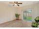 Open-concept living area with modern floors, ceiling fan, and sliding glass doors to the outside at 3823 Parkridge Cir # 1-101, Sarasota, FL 34243