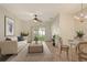 Bright living room featuring a ceiling fan, neutral color palette, and sliding door access to the outdoors at 3823 Parkridge Cir # 1-101, Sarasota, FL 34243