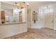 Open living space featuring wood-look floors, modern lighting, and an open view to the kitchen at 3823 Parkridge Cir # 1-101, Sarasota, FL 34243