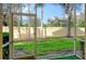 View of a screened patio featuring a well-maintained lawn and a privacy wall, blending indoor/outdoor living at 3823 Parkridge Cir # 1-101, Sarasota, FL 34243