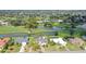 A high aerial view of the property with lush greenery, scenic ponds and a picturesque golf course at 3837 Torrey Pines Blvd, Sarasota, FL 34238