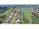 An aerial view showing the real estate, the golf course, and the lake views at 3837 Torrey Pines Blvd, Sarasota, FL 34238