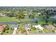 An aerial view showing the real estate, the golf course, and the lake views at 3837 Torrey Pines Blvd, Sarasota, FL 34238