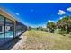 Beautiful backyard with a long water view and screened in pool area at 3837 Torrey Pines Blvd, Sarasota, FL 34238