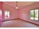 Bedroom with 2 window views, vaulted ceiling and light fixture at 3837 Torrey Pines Blvd, Sarasota, FL 34238