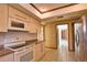 Bright kitchen with modern appliances, granite countertops, and tile flooring at 3837 Torrey Pines Blvd, Sarasota, FL 34238
