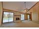 Large living room with a stone fireplace and views of the screened-in pool area at 3837 Torrey Pines Blvd, Sarasota, FL 34238