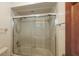 Shower with glass doors, tile surround, and updated fixtures at 3837 Torrey Pines Blvd, Sarasota, FL 34238