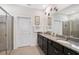 Bright bathroom features a granite countertop, dual sinks, and glass-enclosed shower at 3945 Mossy Limb Ct, Palmetto, FL 34221