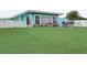 A large, grassy backyard features seating and landscaping; the patio provides space to relax and enjoy the outdoors at 408 Bryn Mawr Is, Bradenton, FL 34207