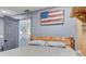 Cozy bedroom featuring a wood accent wall, a comfortable bed, and a relaxing atmosphere at 408 Bryn Mawr Is, Bradenton, FL 34207