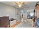 Cozy room with a ceiling fan, desk, and closet with mirrored sliding doors; hardwood floors and neutral walls provide a soothing aesthetic at 408 Bryn Mawr Is, Bradenton, FL 34207