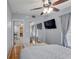 Bright bedroom features wood floors, a ceiling fan, and sliding mirror closet doors at 408 Bryn Mawr Is, Bradenton, FL 34207