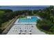Aerial view of the community pool and leisure area, equipped with lounge chairs and tables under the warm sun at 408 Bryn Mawr Is, Bradenton, FL 34207