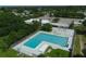 Aerial view of large community pool, surrounded by lush landscaping, and open space perfect for relaxation at 408 Bryn Mawr Is, Bradenton, FL 34207