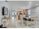 Open floor plan featuring dining area with bar seating, a large table, and an island at 408 Bryn Mawr Is, Bradenton, FL 34207