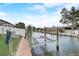 Waterfront view showcasing a private boat lift and dock, perfect for boating enthusiasts and waterfront living at 408 Bryn Mawr Is, Bradenton, FL 34207