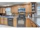 Well-equipped kitchen boasts custom cabinetry, modern appliances, and stylish backsplash, ready for culinary adventures at 408 Bryn Mawr Is, Bradenton, FL 34207