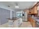 Inviting kitchen featuring custom cabinetry, stainless steel appliances, and a kitchen island with a view of the living room at 408 Bryn Mawr Is, Bradenton, FL 34207