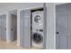 A laundry closet shows a stacked washer and dryer; unit is centrally located and easily accessible to other rooms in the home at 408 Bryn Mawr Is, Bradenton, FL 34207