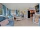 Open living room with comfortable seating, tile flooring, and coastal decor, leading to an adjacent kitchen area at 408 Bryn Mawr Is, Bradenton, FL 34207