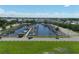 Aerial view of a bustling marina, showcasing multiple boats docked in a calm harbor under a bright sky at 408 Bryn Mawr Is, Bradenton, FL 34207