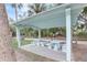 Outdoor pavilion features a shaded picnic area with tables and benches surrounded by trees at 408 Bryn Mawr Is, Bradenton, FL 34207