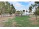 Picturesque playground with lush green grass, trees, and slides provides a fun and safe environment for children at 408 Bryn Mawr Is, Bradenton, FL 34207