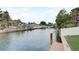 Wide canal view with seawall and docks extending toward waterfront homes and palm trees in a waterfront community at 408 Bryn Mawr Is, Bradenton, FL 34207