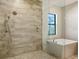 Stunning bathroom features a glass-enclosed shower with dual shower heads and a soaking tub at 428 Bocelli Dr, North Venice, FL 34275