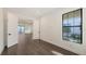 Bright bedroom boasts sleek hardwood floors, an expansive window, and an open doorway to another room at 428 Bocelli Dr, North Venice, FL 34275