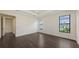 Spacious bedroom with hardwood floors, tray ceiling, and pool view from large windows at 428 Bocelli Dr, North Venice, FL 34275