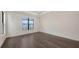 Bright bedroom with hardwood floors and a large window overlooking the screened lanai and pool at 428 Bocelli Dr, North Venice, FL 34275