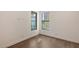 Bright bedroom with sleek hardwood floors, white walls and contrasting dark window frames, offers a modern aesthetic at 428 Bocelli Dr, North Venice, FL 34275