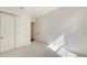 Cozy bedroom with neutral carpet, bright white walls and trim, and sliding closet doors at 428 Bocelli Dr, North Venice, FL 34275