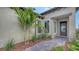 Front entrance with small palms and pavers leading to front door at 428 Bocelli Dr, North Venice, FL 34275