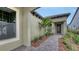 A covered entrance featuring pavers and lush landscaping at 428 Bocelli Dr, North Venice, FL 34275