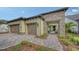 Charming single-Gathering home featuring a two-car garage and an arched entry over a beautifully paved driveway at 428 Bocelli Dr, North Venice, FL 34275