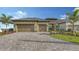 Charming single-Gathering home featuring a two-car garage, tile roof, and a beautifully paved driveway at 428 Bocelli Dr, North Venice, FL 34275