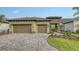 Charming single-Gathering home featuring a two-car garage, tile roof, and a beautifully paved driveway at 428 Bocelli Dr, North Venice, FL 34275