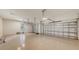 Spacious three-car garage with epoxy flooring, overhead lighting, and windows for natural light at 428 Bocelli Dr, North Venice, FL 34275