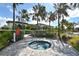 Relaxing hot tub surrounded by lush tropical landscape and close to the community pool at 428 Bocelli Dr, North Venice, FL 34275