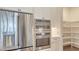 Modern kitchen with stainless steel refrigerator, built-in double ovens, and walk in pantry with wire shelving at 428 Bocelli Dr, North Venice, FL 34275