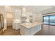 Modern kitchen with a large island, stainless steel appliances, white cabinets, and access to the pool area at 428 Bocelli Dr, North Venice, FL 34275