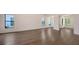 Bright living room boasts sleek hardwood floors and large windows, offering a modern aesthetic at 428 Bocelli Dr, North Venice, FL 34275