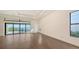 Bright, open-concept living area with hardwood flooring, large windows, and sliding glass doors to the pool at 428 Bocelli Dr, North Venice, FL 34275