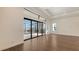 Bright living room with wood flooring, tray ceilings, recessed lighting, and access to the screened-in lanai at 428 Bocelli Dr, North Venice, FL 34275