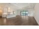 Spacious living room with hardwood floors and large sliding doors overlooking the water at 428 Bocelli Dr, North Venice, FL 34275